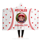 A white hooded blanket featuring red stitching designed to look like a baseball, with small red hearts scattered throughout